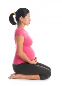 Prenatal yoga. Full length healthy Asian pregnant woman meditating at home, fullbody isolated on white background. Yoga hero pose.